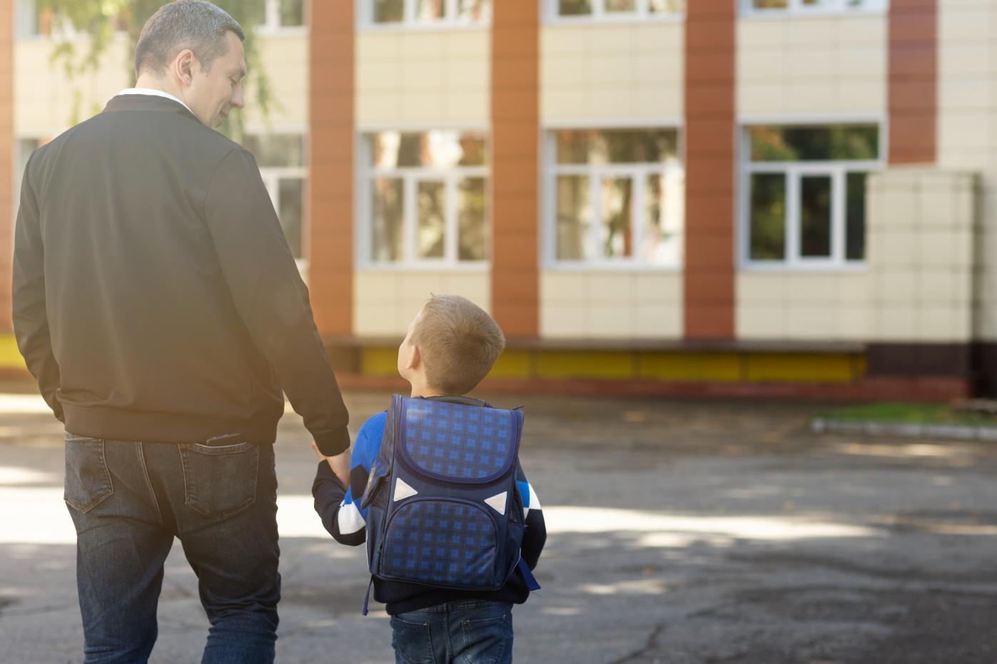 father-kid-first-school-day-back-view-1 image father kid first school day back view 1